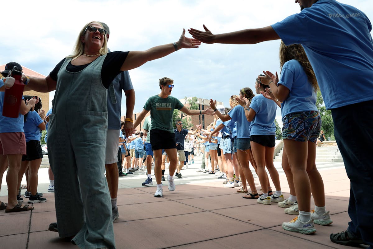 A welcome tunnel is formed by 150 returning students to welcome incoming first-year students. Photo by Jamie Cotten / Colorado College